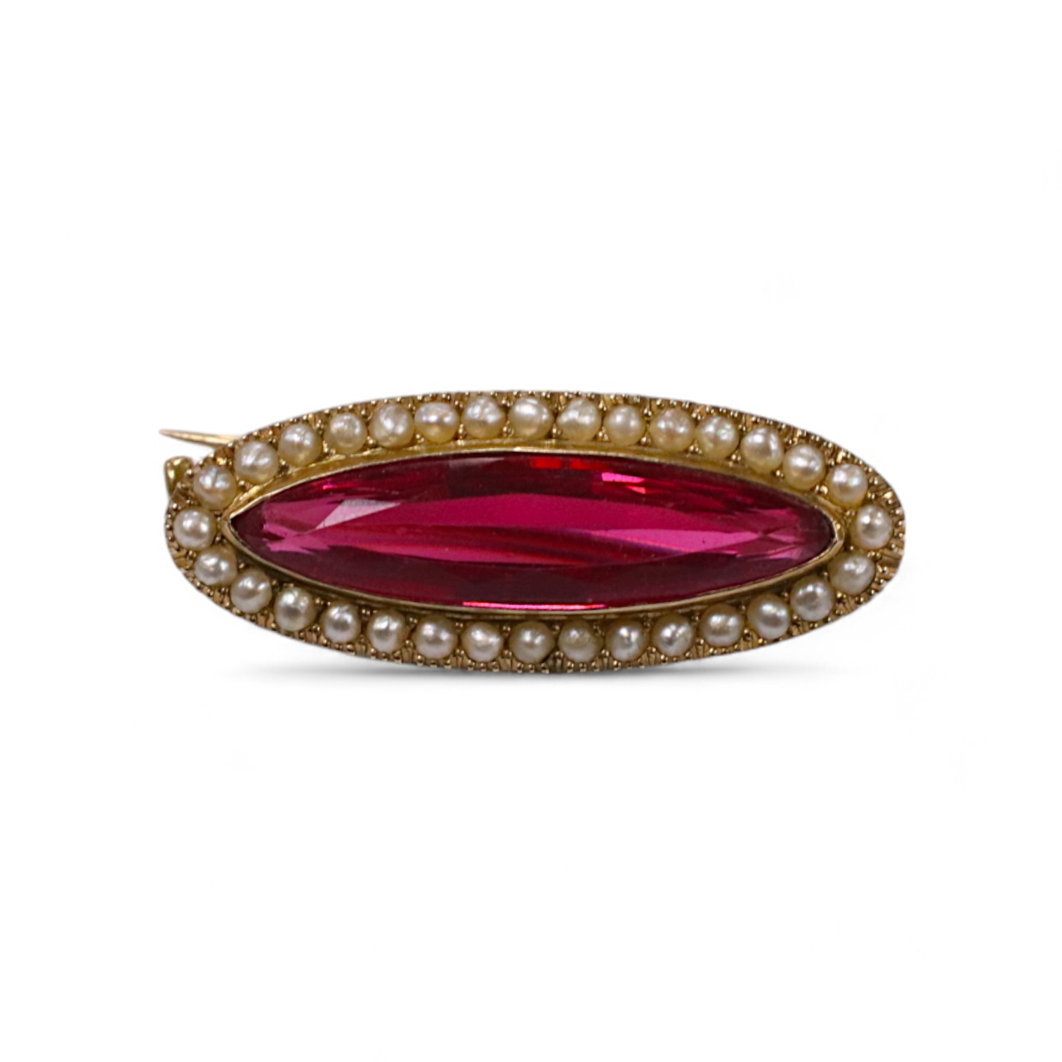 A 9ct, red paste and seed pearl set navette shaped brooch, 31mm, gross weight 4.2 grams. Condition - good